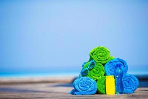 Stacked towels and sunscreen photo