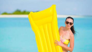 Woman with a floatie near a beach photo