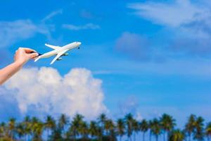 Person holding toy airplane outside photo