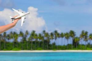 Hand holding toy airplane photo