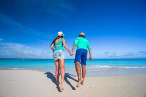 Couple running on a beach photo