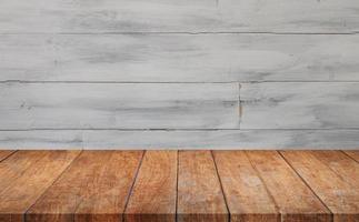 Wooden table against gray wood wall photo