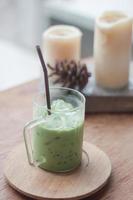 Iced green tea latte with candles photo