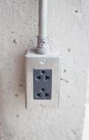 Power socket on concrete wall photo