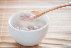 Bowl of bua loi with a wooden spoon photo