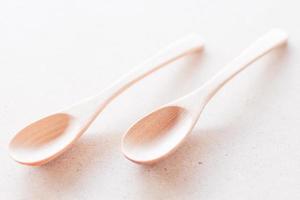 Two wooden spoons on a white background photo