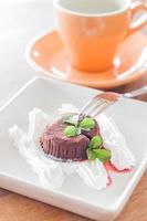 Chocolate lava cake with a fork and a coffee cup photo