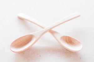 Empty spoons crossing on a white background photo