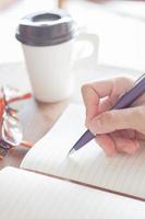 Woman writing on a notebook photo