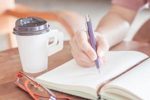 Woman writing on notepaper photo