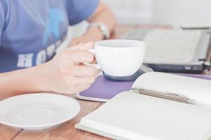 Person working while drinking coffee photo