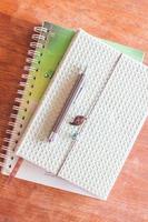 Top view of a pen on two notebooks photo
