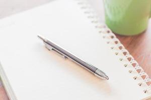 Close-up of a pen and spiral notebook photo