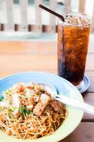 Stir fried spicy noodles and a cola photo