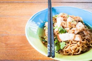 Stir fried spicy noodles with chopsticks photo