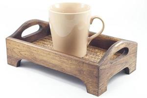 Light brown mug on a wooden tray photo