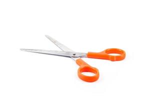Orange scissors on a white background photo