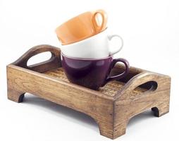 Stacked coffee cups on a wooden tray photo