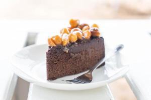 Macadamia chocolate cake on minimal white background photo