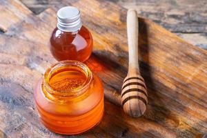 Organic honey on wooden table photo