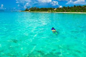 Man snorkeling in clear water photo