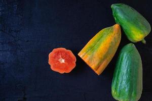 Fresh papaya on black background photo