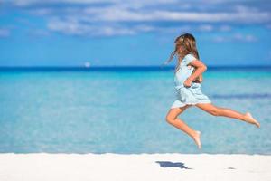 Girl leaping on a beach photo