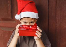 Boy with gift box on Christmas day photo