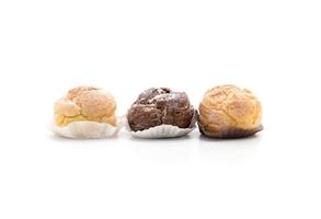 Cream puffs on white background photo