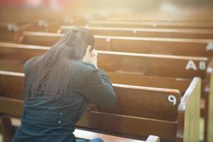 Beautiful asia woman praying in the morning at church.