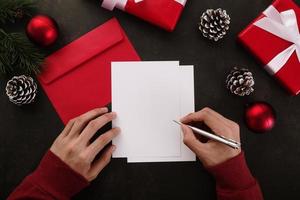 manos escribiendo maqueta de tarjeta de felicitación blanca