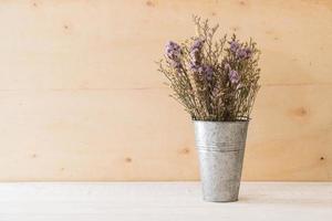 Statice and caspia flowers on wooden background photo