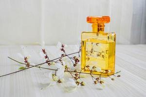 Perfume bottle and flowers photo