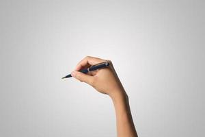 A woman's hand holds a pen isolated on white background photo