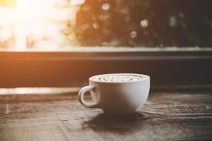 A cup of coffee on wooden table photo