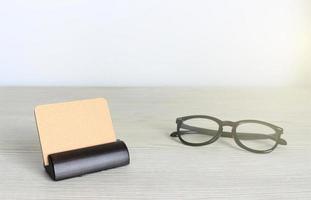 Blank business cards and glasses on wooden office table