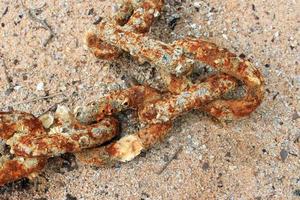 Rusted chain on the beach photo