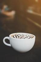 A cup of coffee on wooden table photo