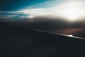 Airplane wing in a dark sky photo