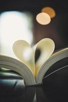 Curled paper in the shape of a heart with blurred bokeh photo