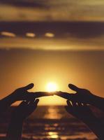 Silhouette of hands at sunset photo