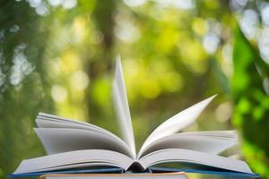 Close-up of open book with nature bokeh background photo