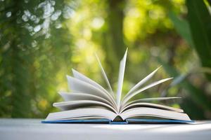 Close-up of open book with nature bokeh background photo