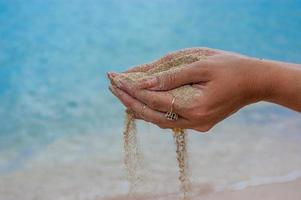 Hands holding sand photo