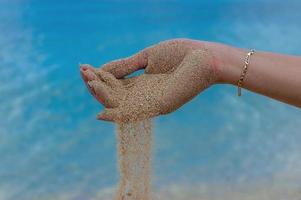 Hand dispensing sand photo