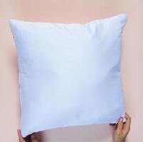 Person holding a white pillow photo