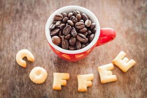 Top view of coffee alphabet biscuits with a red coffee cup photo