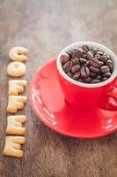 Coffee alphabet biscuits with a red coffee cup photo