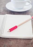 Red pencil and notebook photo