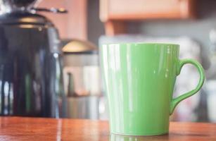 Green coffee mug in a cafe photo